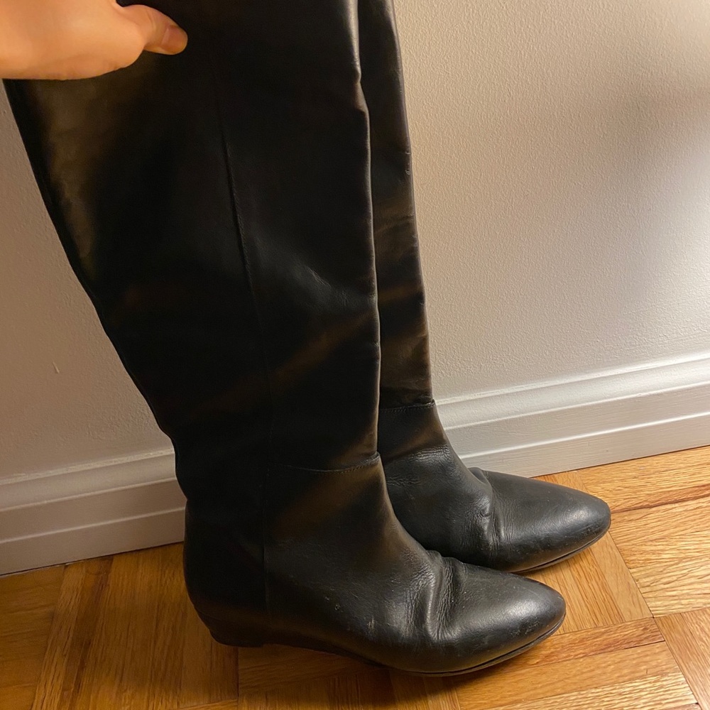 Tall knee length black leather boots